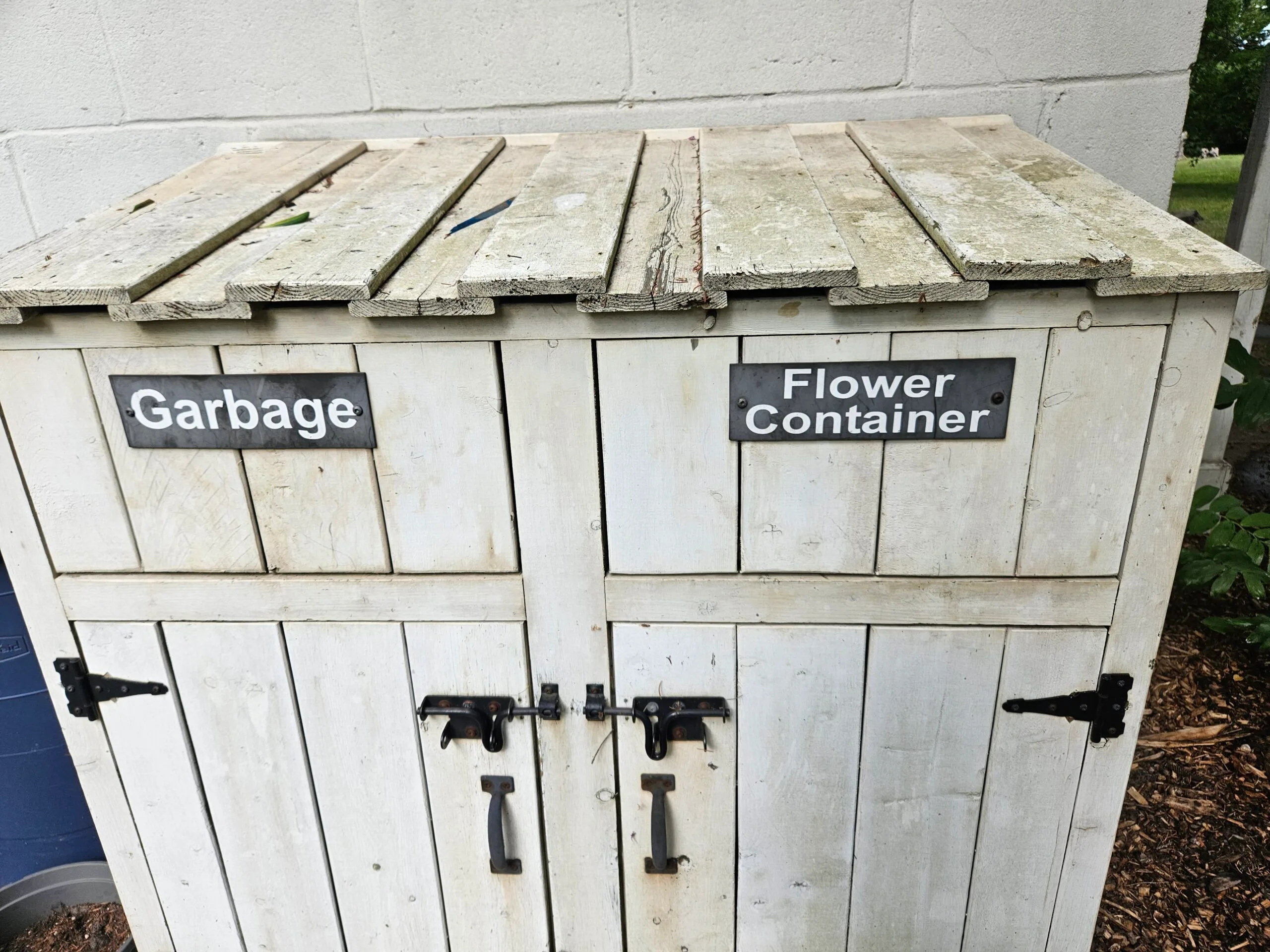 white, wooden, outdoor cabinet for returning loaned cemetery vases
